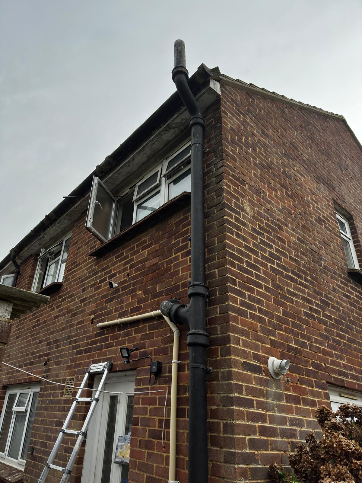 Asbestos cement soil stack before removal