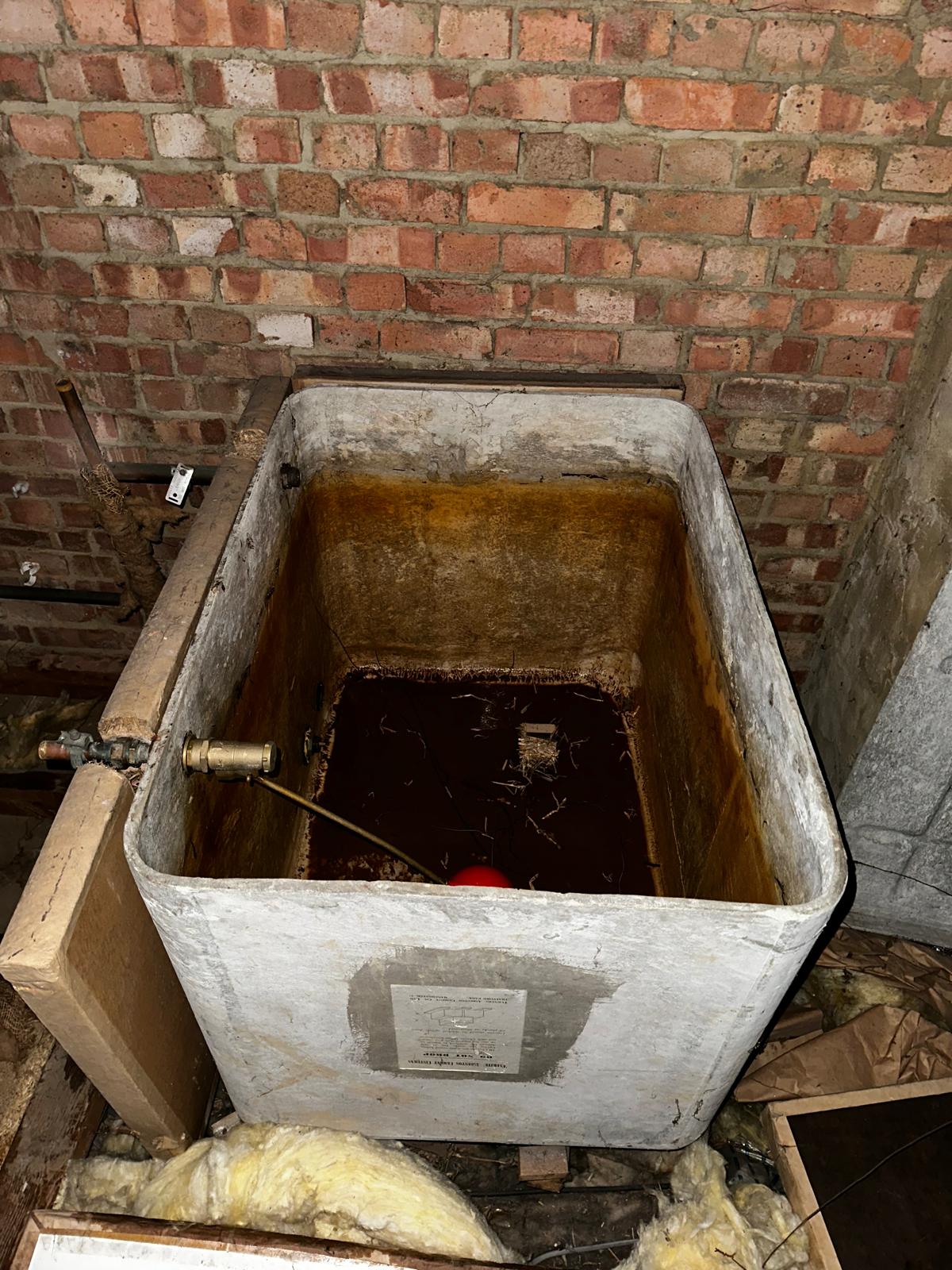 Asbestos water tank in loft before removal